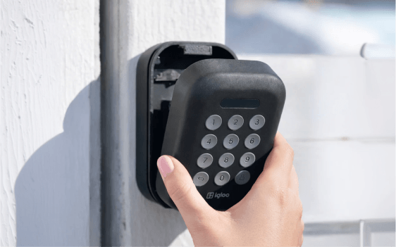 A guest entering a PIN on an igloo lockbox to collect the keys for a self check-in