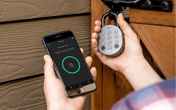 An operator unlocking an igloo smart padlock on a rental door with the igloohome app