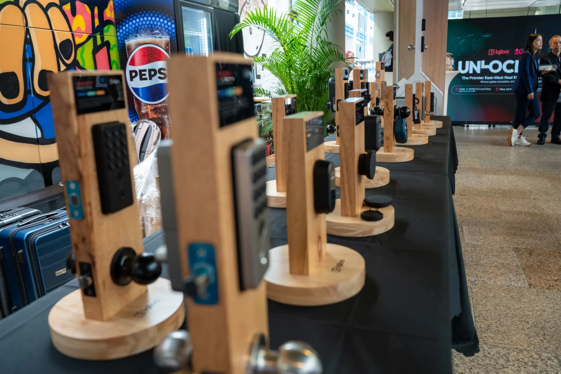 Rows of igloo smart locks on wooden display stands at the UNLOCKED26 showcase