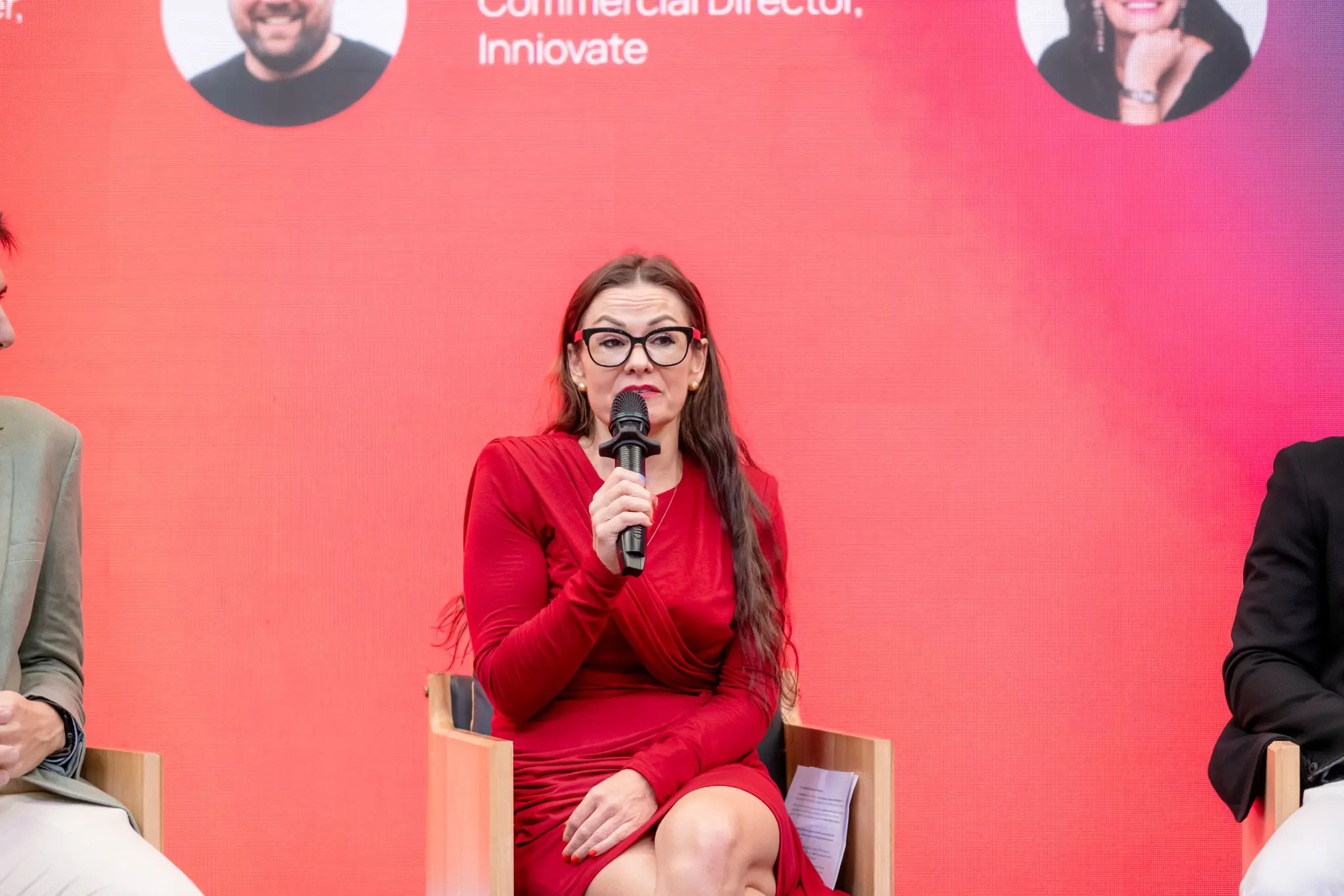Panellist in a red dress speaking during a panel at UNLOCKED26