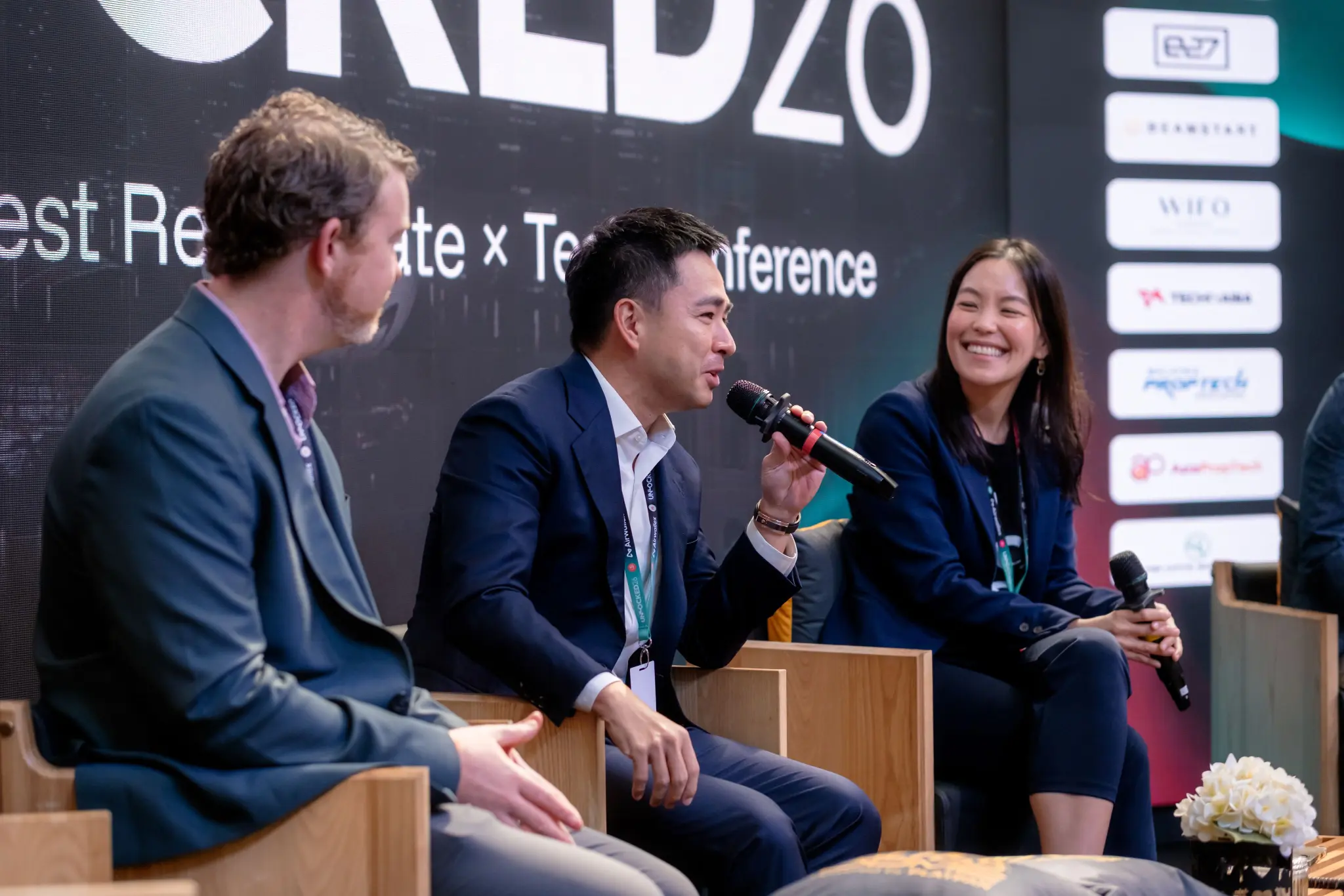 Three panellists in discussion on the UNLOCKED26 main stage