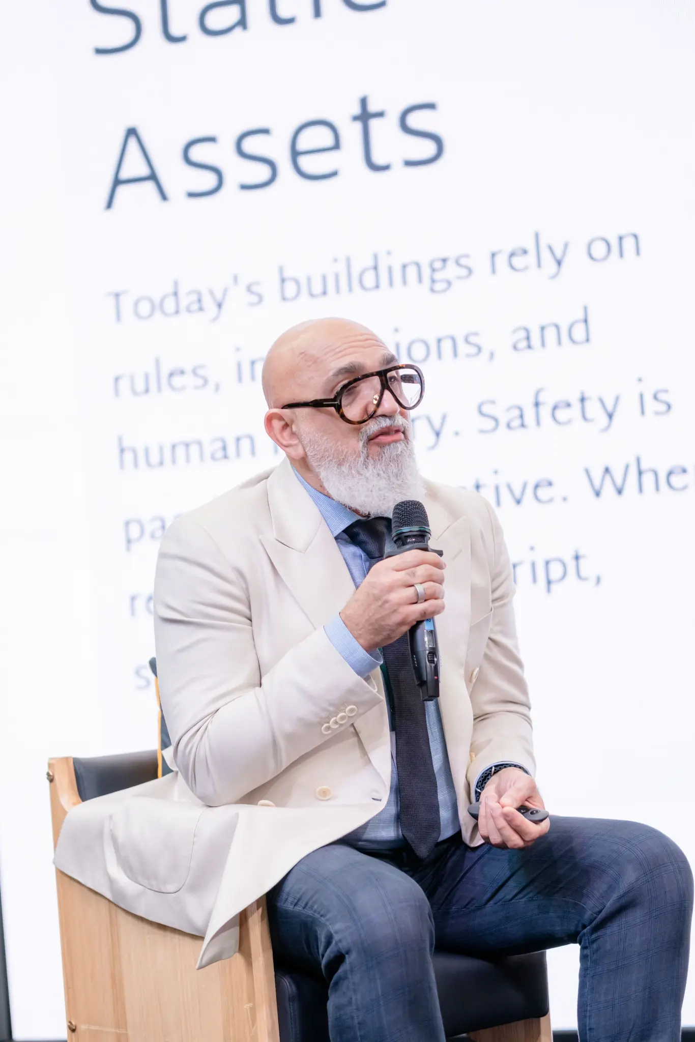 Panellist in a cream blazer speaking about static assets at UNLOCKED26