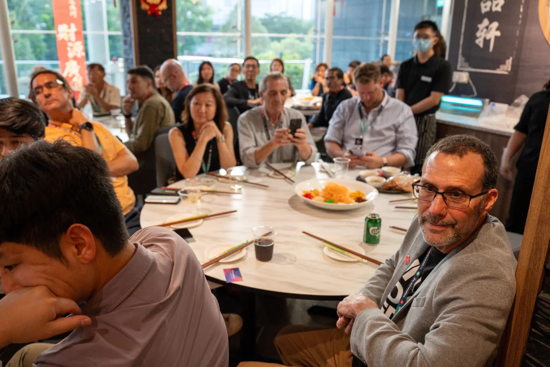 Attendees around a round dining table at the UNLOCKED26 networking dinner