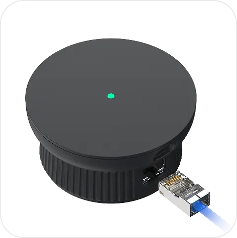 The igloo Bridge 2 seated on the ridged AE1 Network Adapter, a blue Ethernet cable plugged into the adapter's port