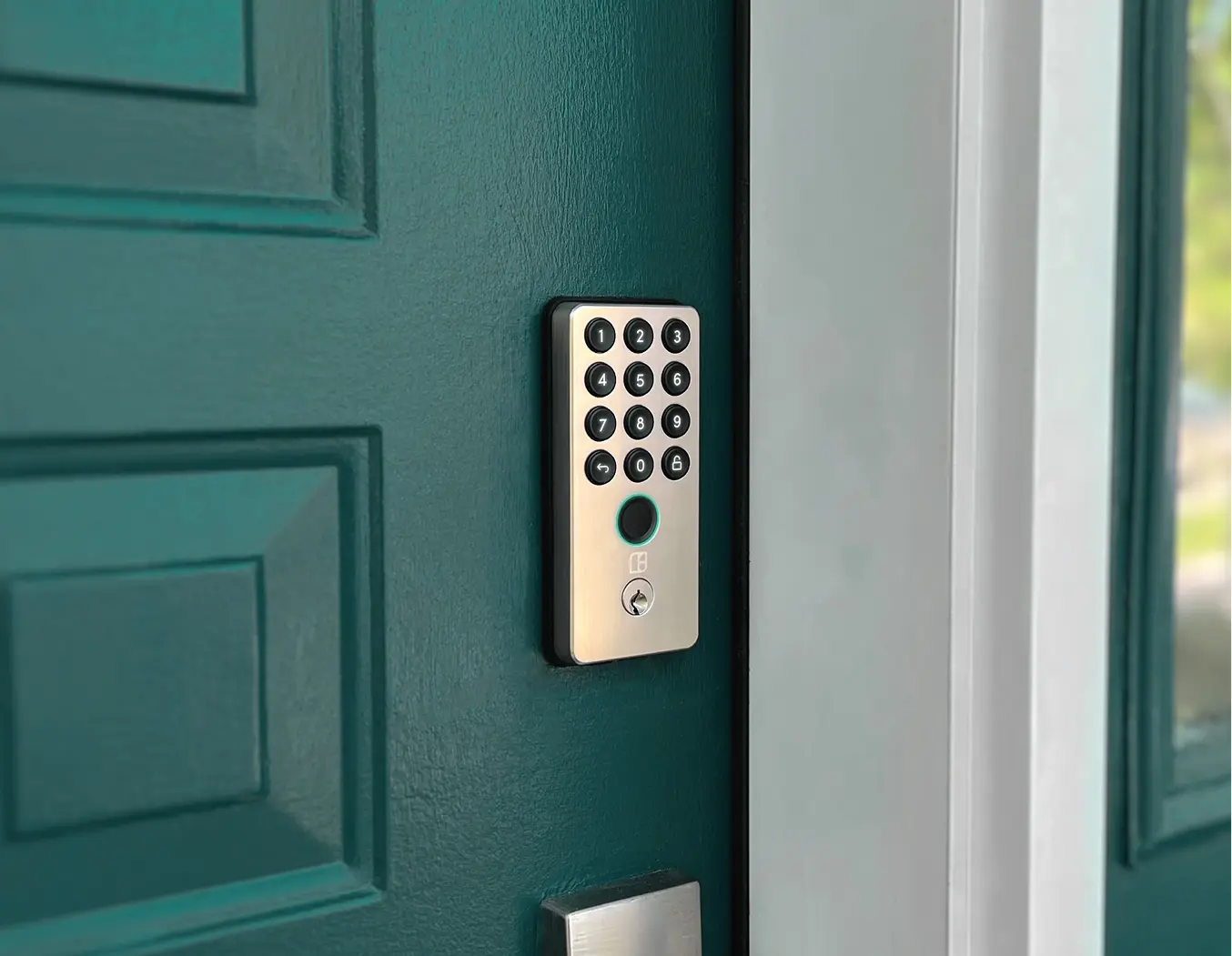 A satin nickel igloo Deadbolt Go with keypad and fingerprint reader fitted to a teal front door