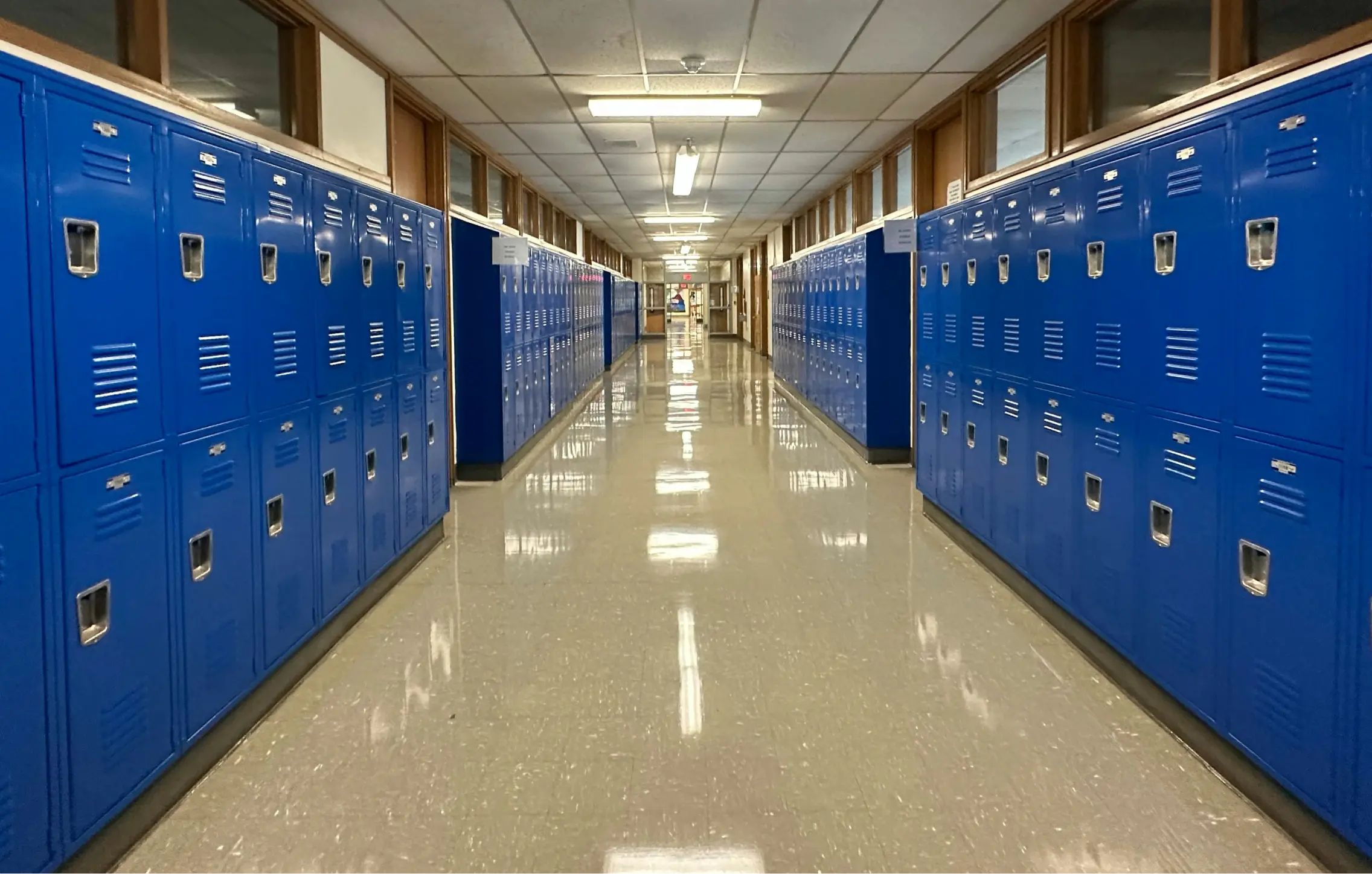A bank of blue lockers lining a hallway