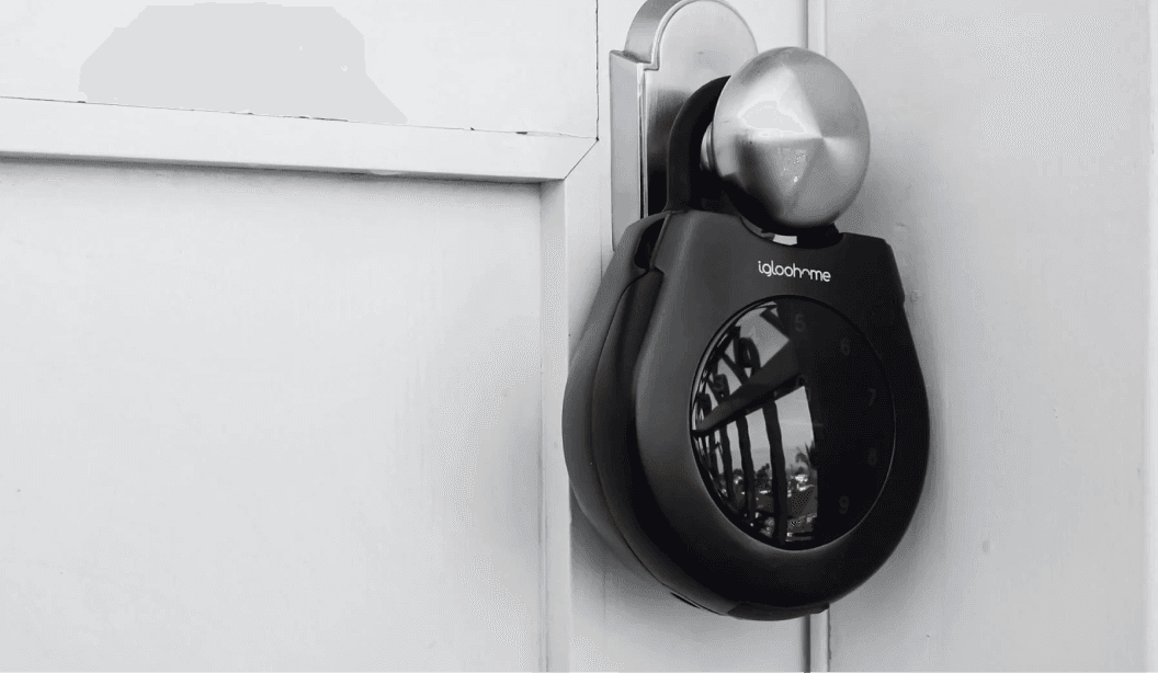 An igloo Keybox 3 hung on a rental home door knob for key handover