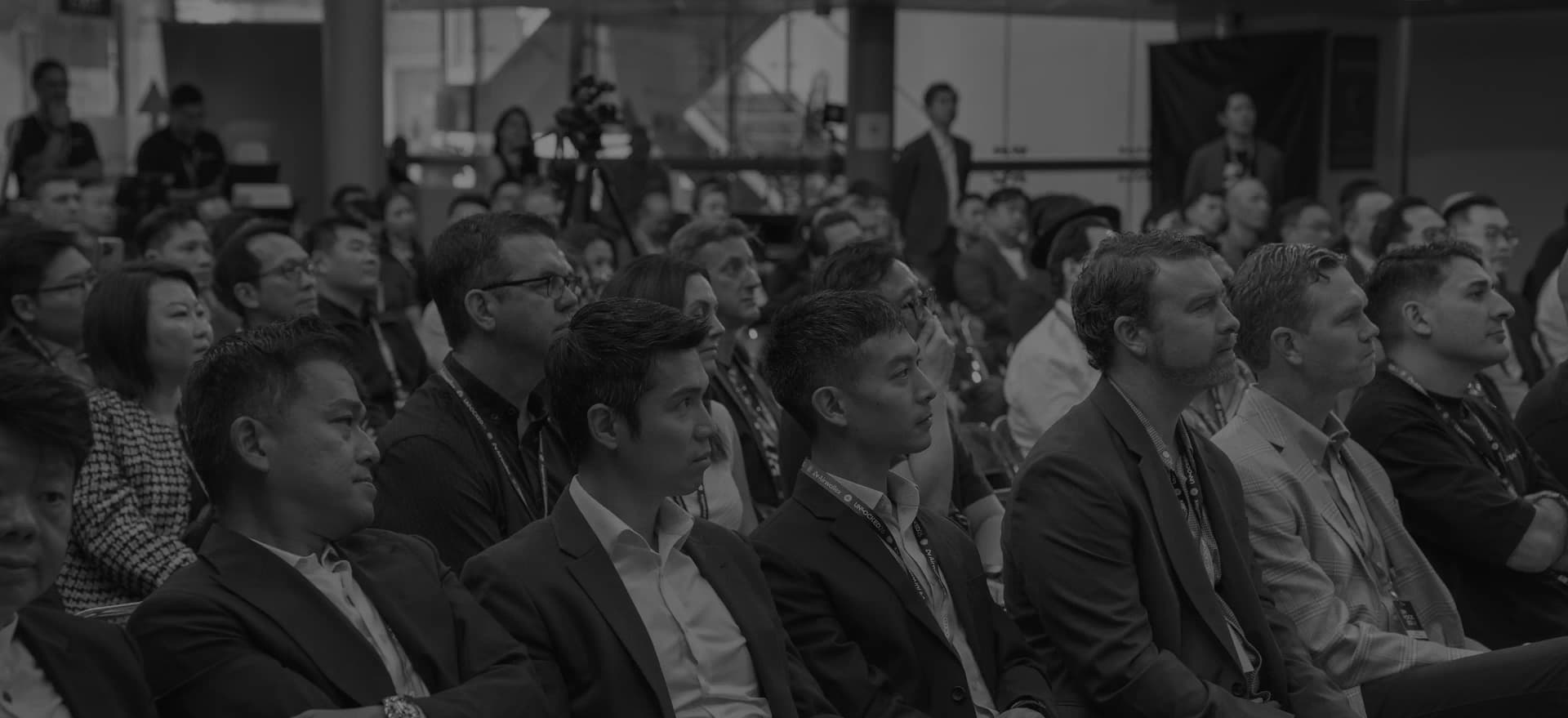 Black-and-white photo of the UNLOCKED26 Singapore audience seated and listening to a talk