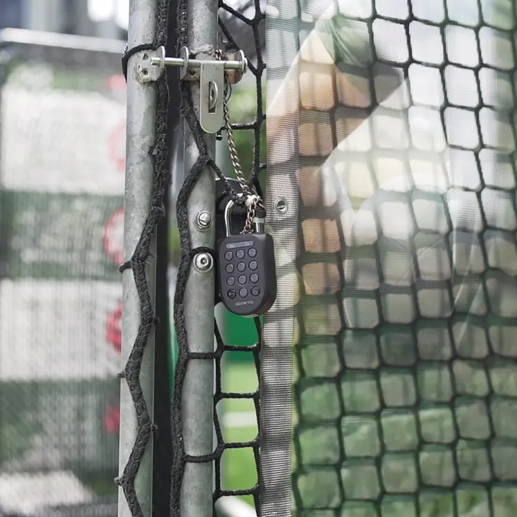 An igloo smart padlock on the access gate of a self-serve futsal court