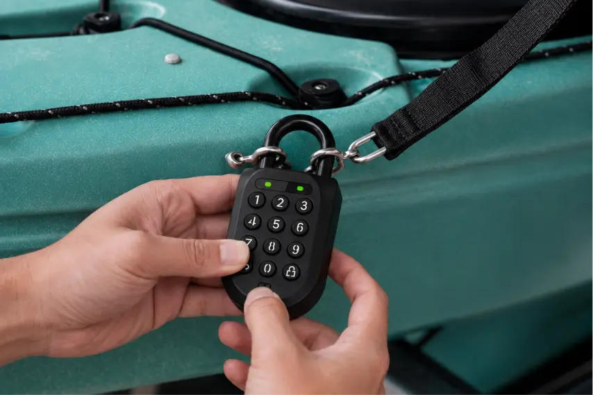 An igloo smart padlock securing a self-serve kayak rack beside the water